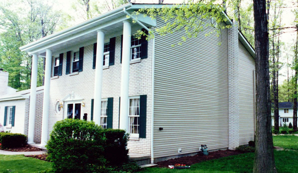 white house with dark shutters and door