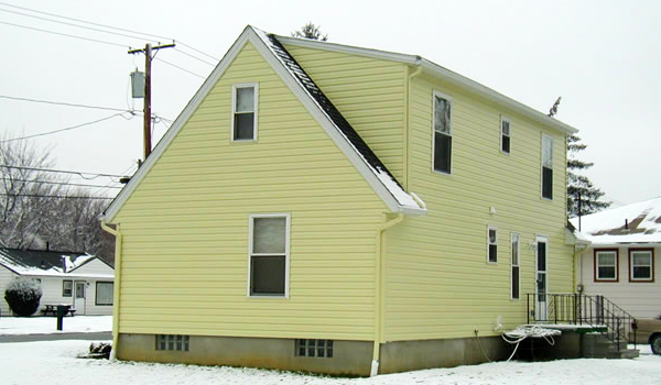house with yellow siding and yellow gutters