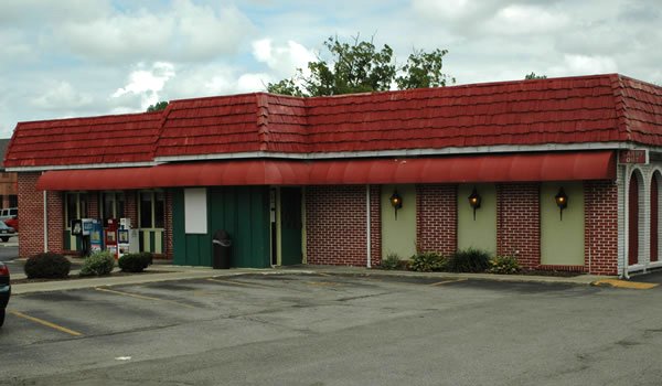 brick building with red awning