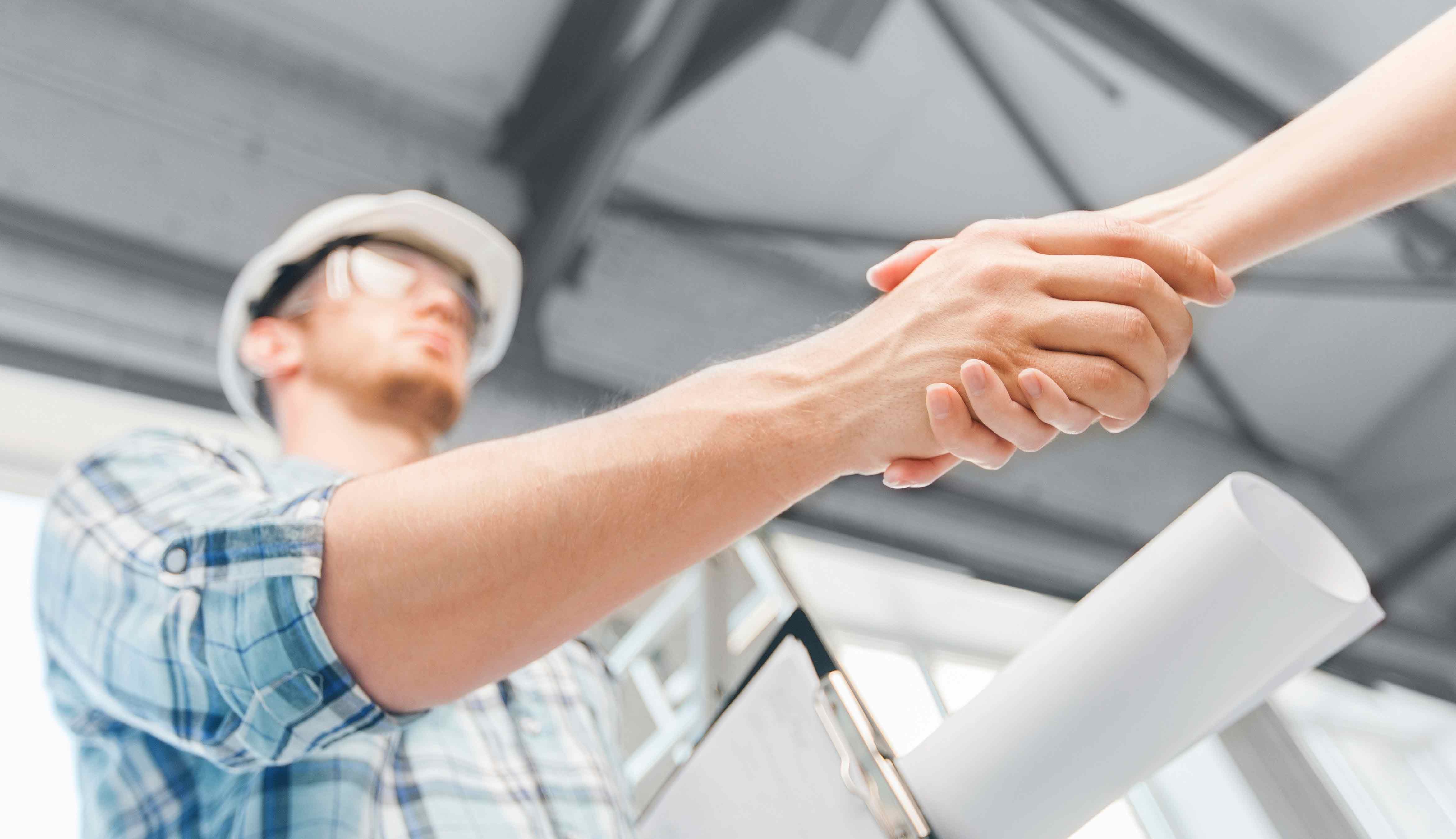 contractor shaking hands with a customer